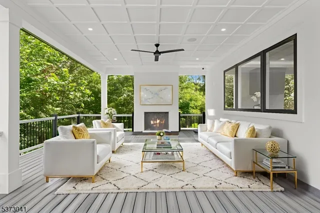 a living room with patio furniture and a fireplace