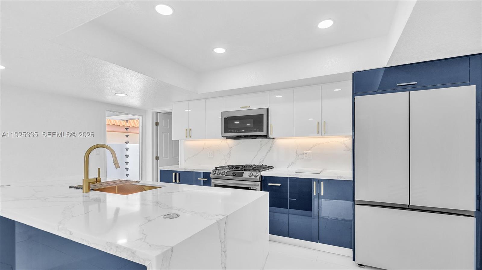 11421 Southwest 84th Street, Unit 1 Miami, FL 33173 - Photo 11 of 44 a kitchen with stainless steel appliances a refrigerator and a stove
