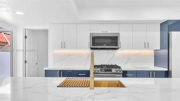 a kitchen with a stove a microwave and refrigerator