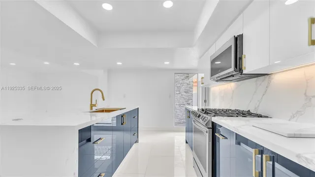 a kitchen that has a sink a stove and a wooden cabinets