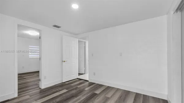 a view of wooden floor and windows in a room