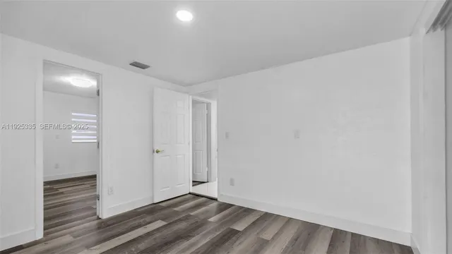a view of wooden floor and windows in a room