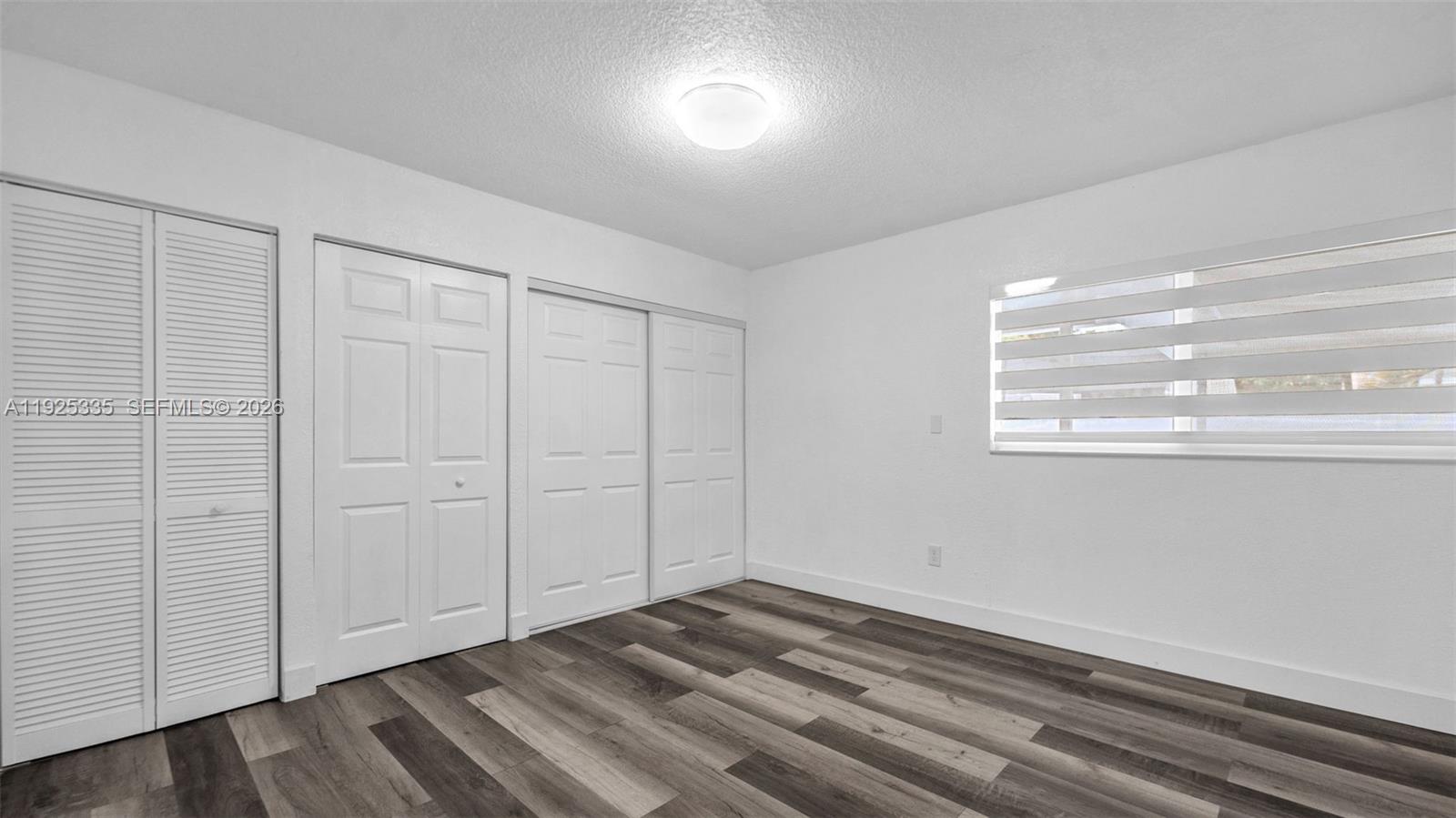 11421 Southwest 84th Street, Unit 1 Miami, FL 33173 - Photo 26 of 44 a view of empty room with wooden floor