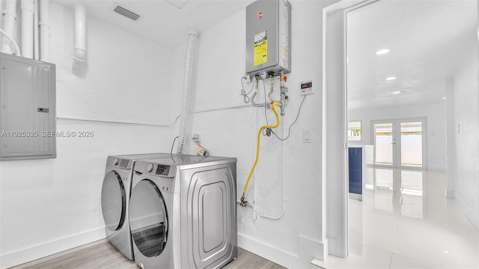 11421 Southwest 84th Street, Unit 1 Miami, FL 33173 - Photo 35 of 44 a utility room with dryer and washer