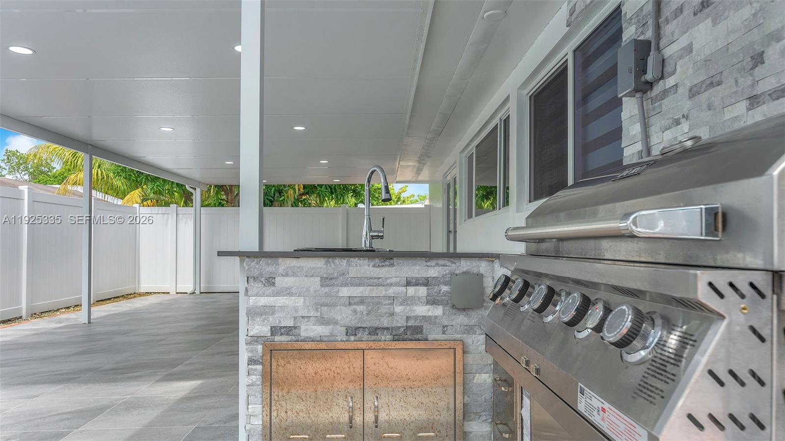 11421 Southwest 84th Street, Unit 1 Miami, FL 33173 - Photo 41 of 44 a kitchen with a stove and a wooden floor