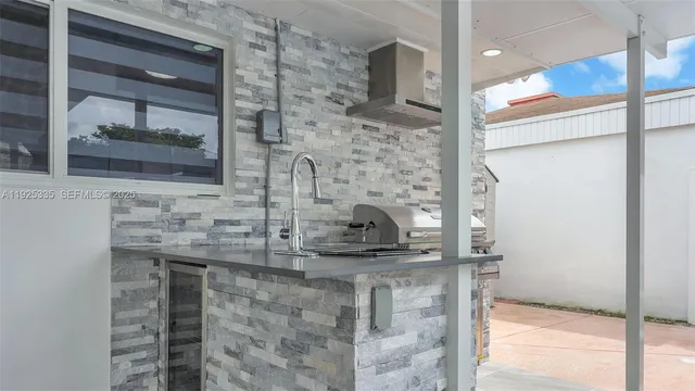 a kitchen with a stove and a wooden floor