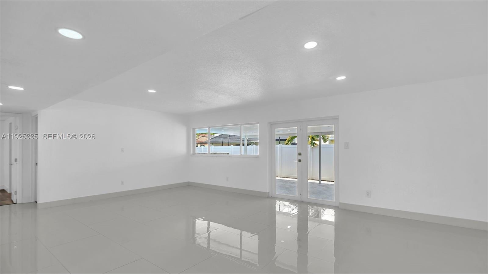11421 Southwest 84th Street, Unit 1 Miami, FL 33173 - Photo 6 of 44 wooden floor in an empty room with a window