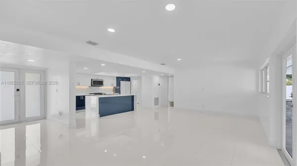 a view of kitchen with refrigerator and window