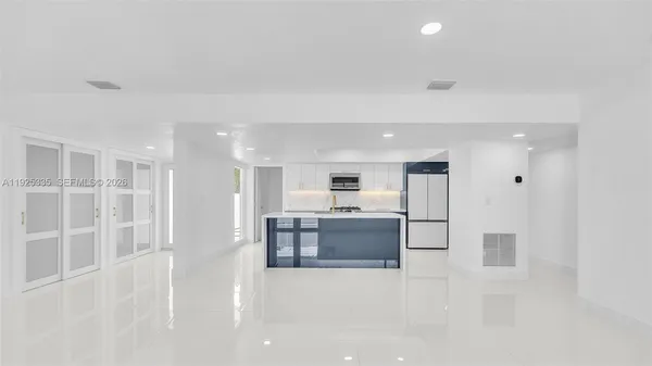 a view of kitchen and refrigerator