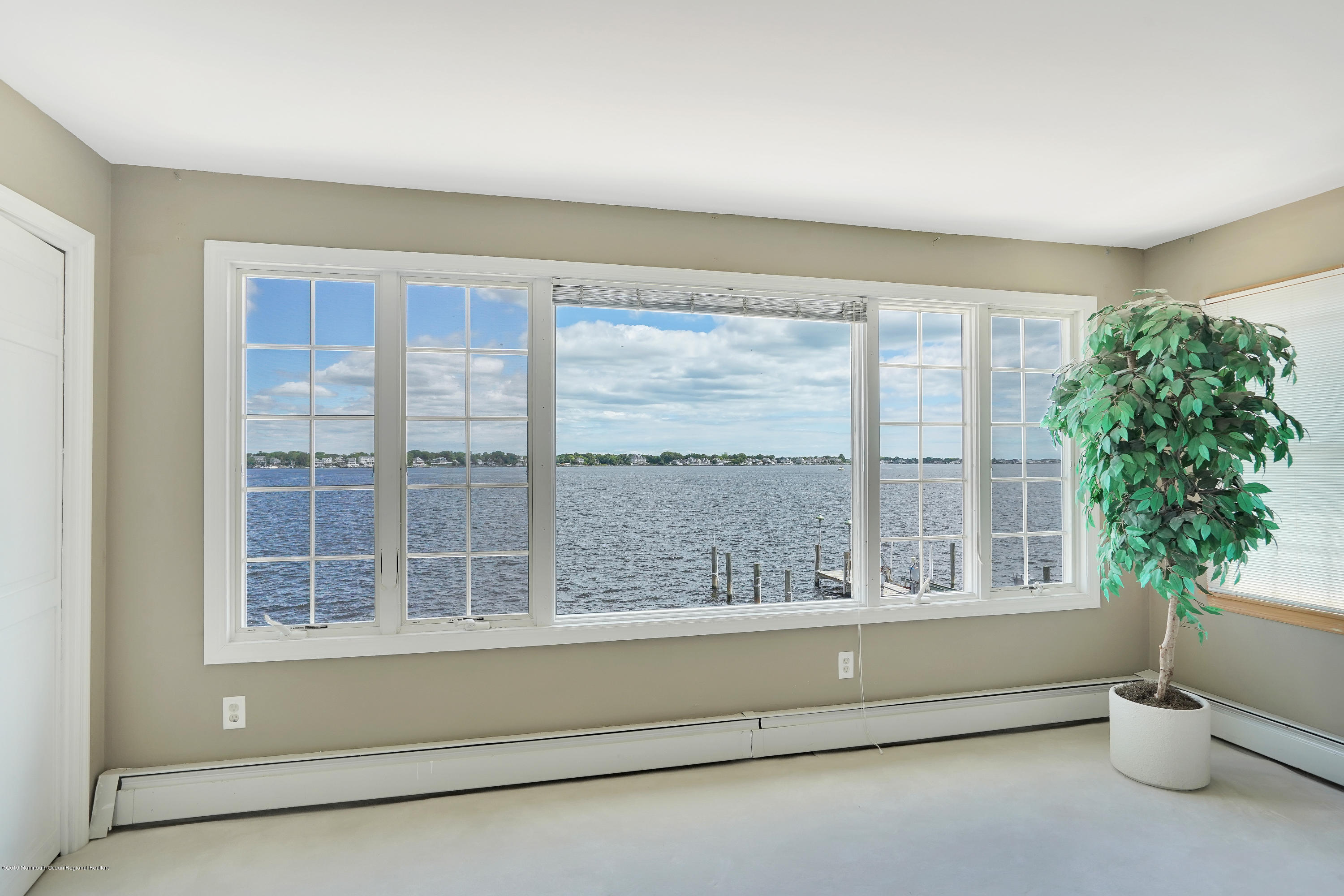 33 Hulse Landing Road Brick, NJ 08723 - Photo 23 of 42 a living room with a large window and a potted plant