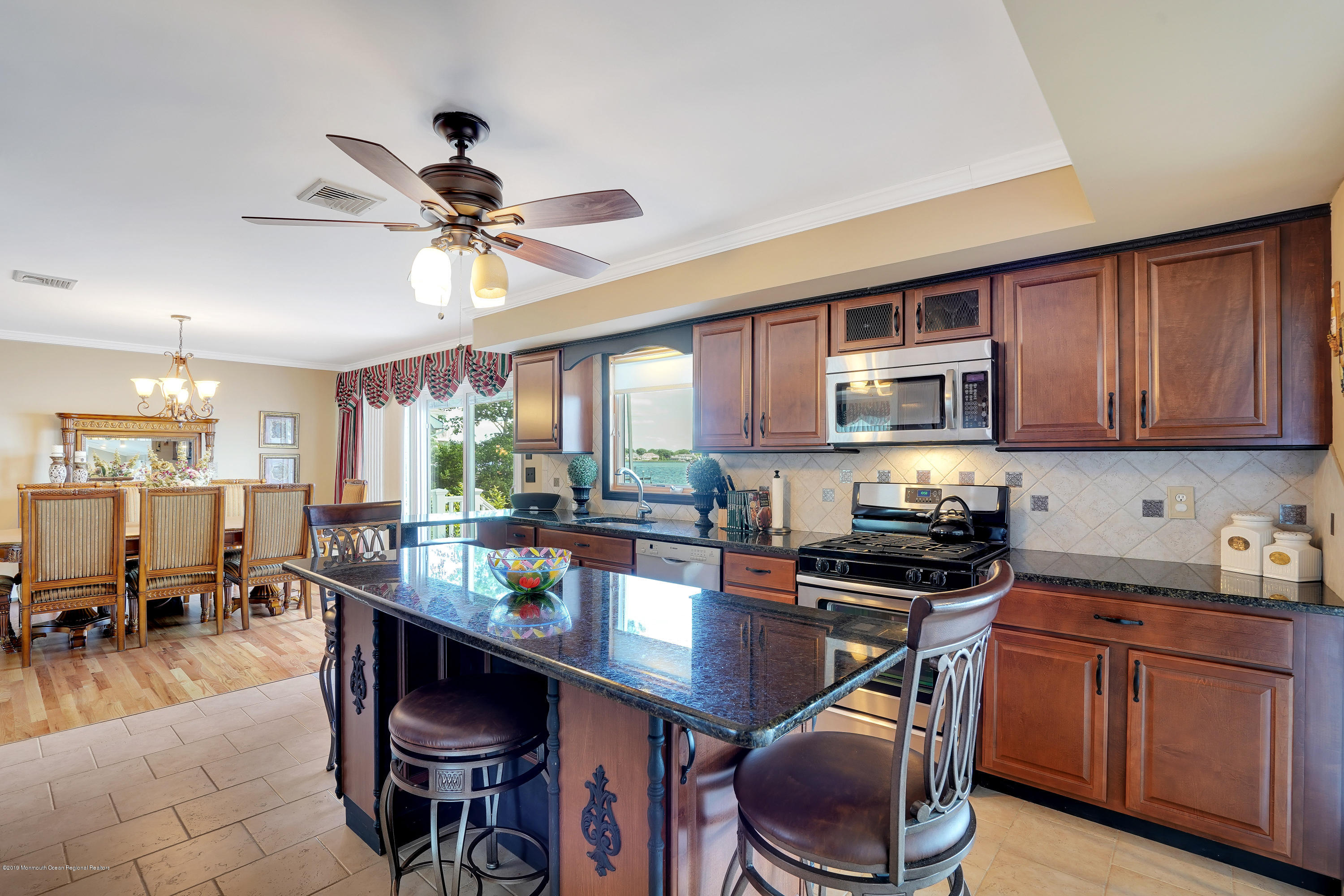 33 Hulse Landing Road Brick, NJ 08723 - Photo 7 of 42 a kitchen with stainless steel appliances granite countertop a stove top oven a sink a dining table and chairs with wooden floor