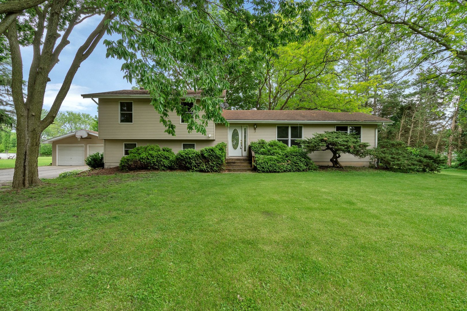 13130 McKanna Road Minooka, IL 60447 - Photo 1 of 56 a view of house in front of a big yard with large trees
