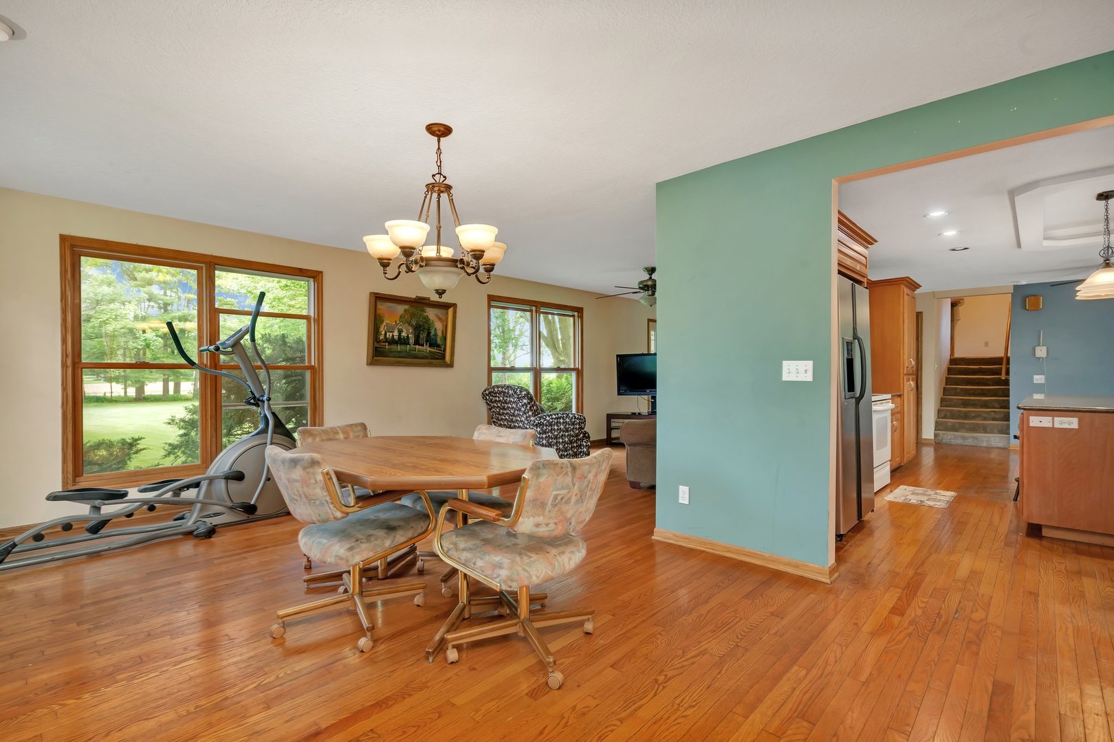 13130 McKanna Road Minooka, IL 60447 - Photo 16 of 56 a dining room with furniture a chandelier and wooden floor