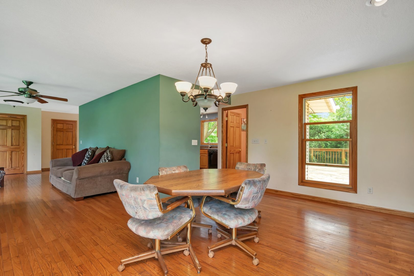 13130 McKanna Road Minooka, IL 60447 - Photo 17 of 56 a dining room with furniture a chandelier and wooden floor