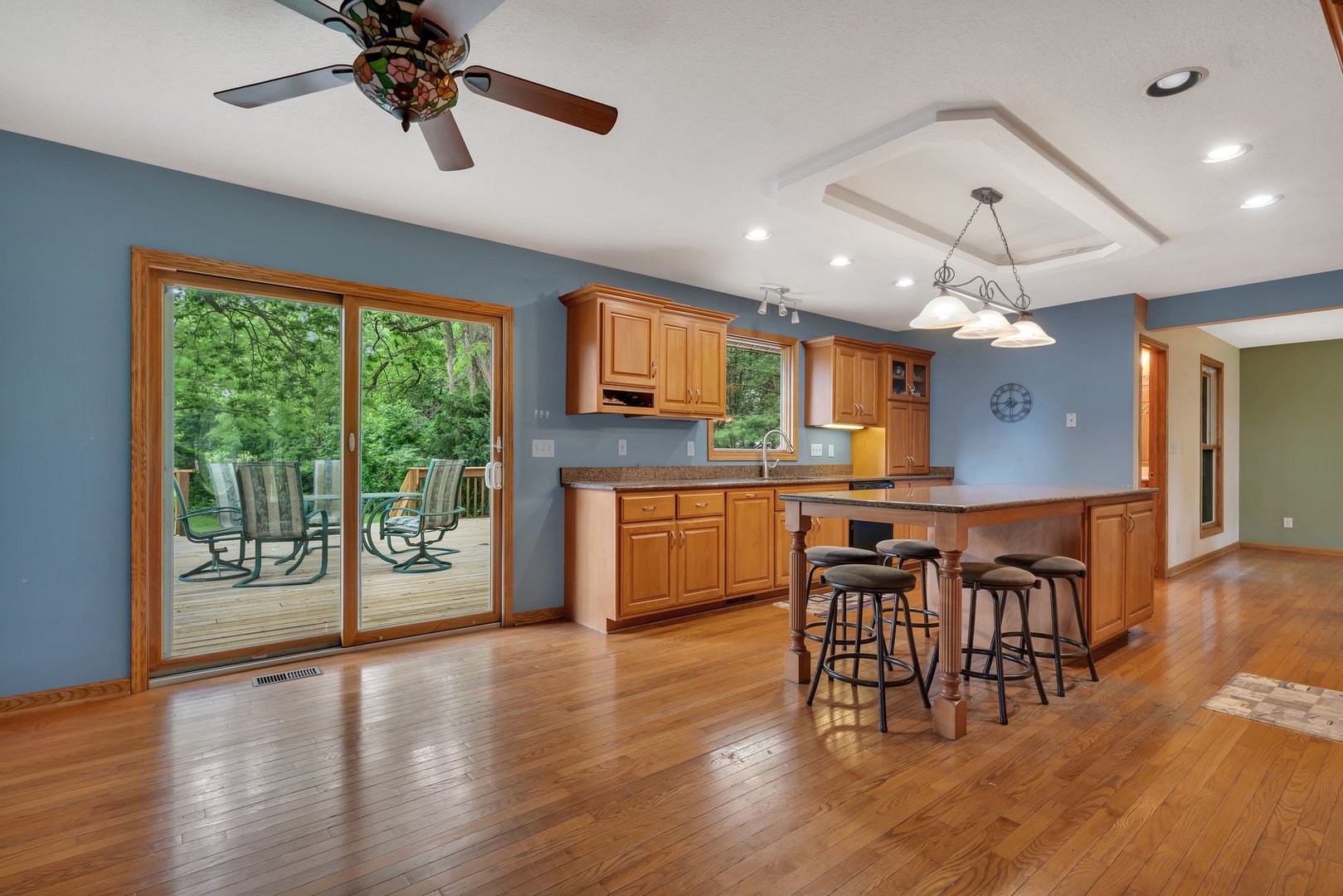 13130 McKanna Road Minooka, IL 60447 - Photo 7 of 56 an open kitchen with wooden floor and chandelier