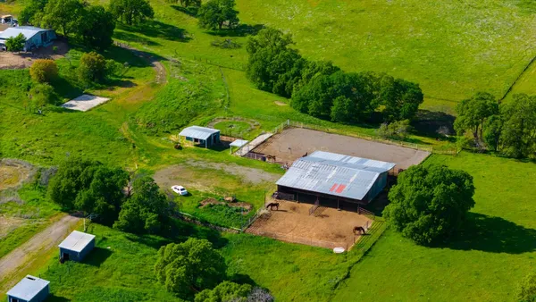 an aerial view of a house with garden space and street view