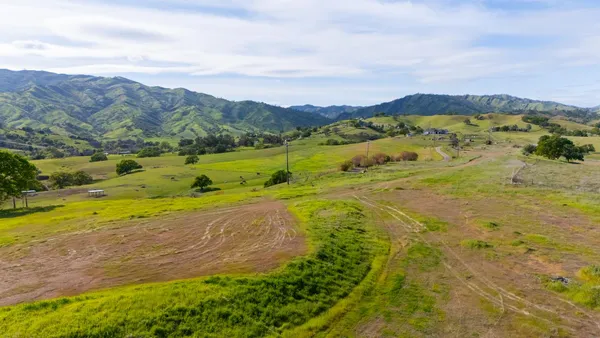 a view of a field with an ocean