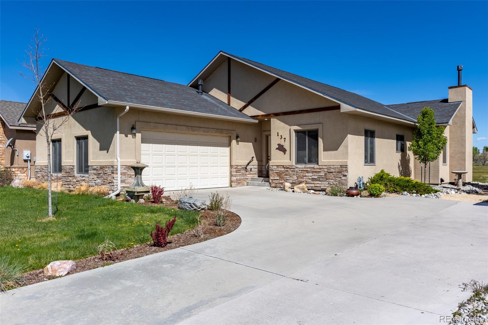 a front view of house with yard and green space