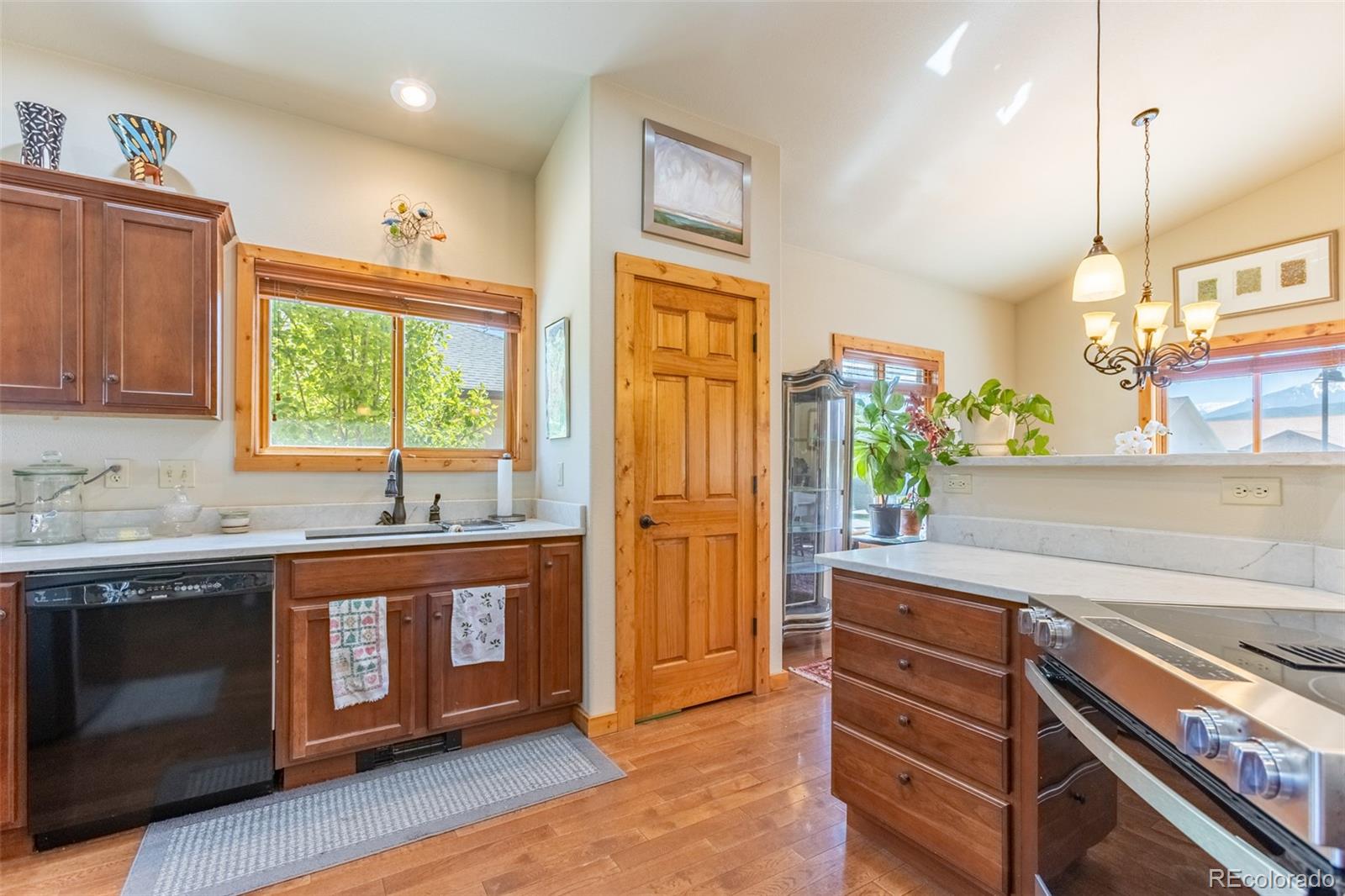 137 Starbuck Circle Salida, CO 81201 - Photo 19 of 50 a kitchen with stainless steel appliances granite countertop a stove a sink and a refrigerator