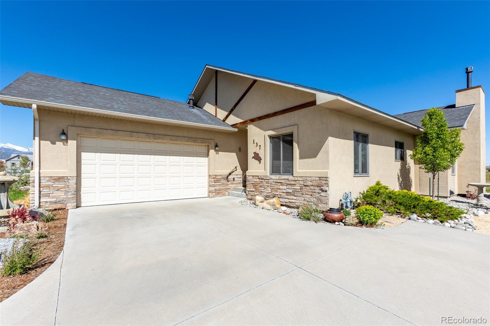 137 Starbuck Circle Salida, CO 81201 - Photo 2 of 50 a front view of a house with a yard and garage