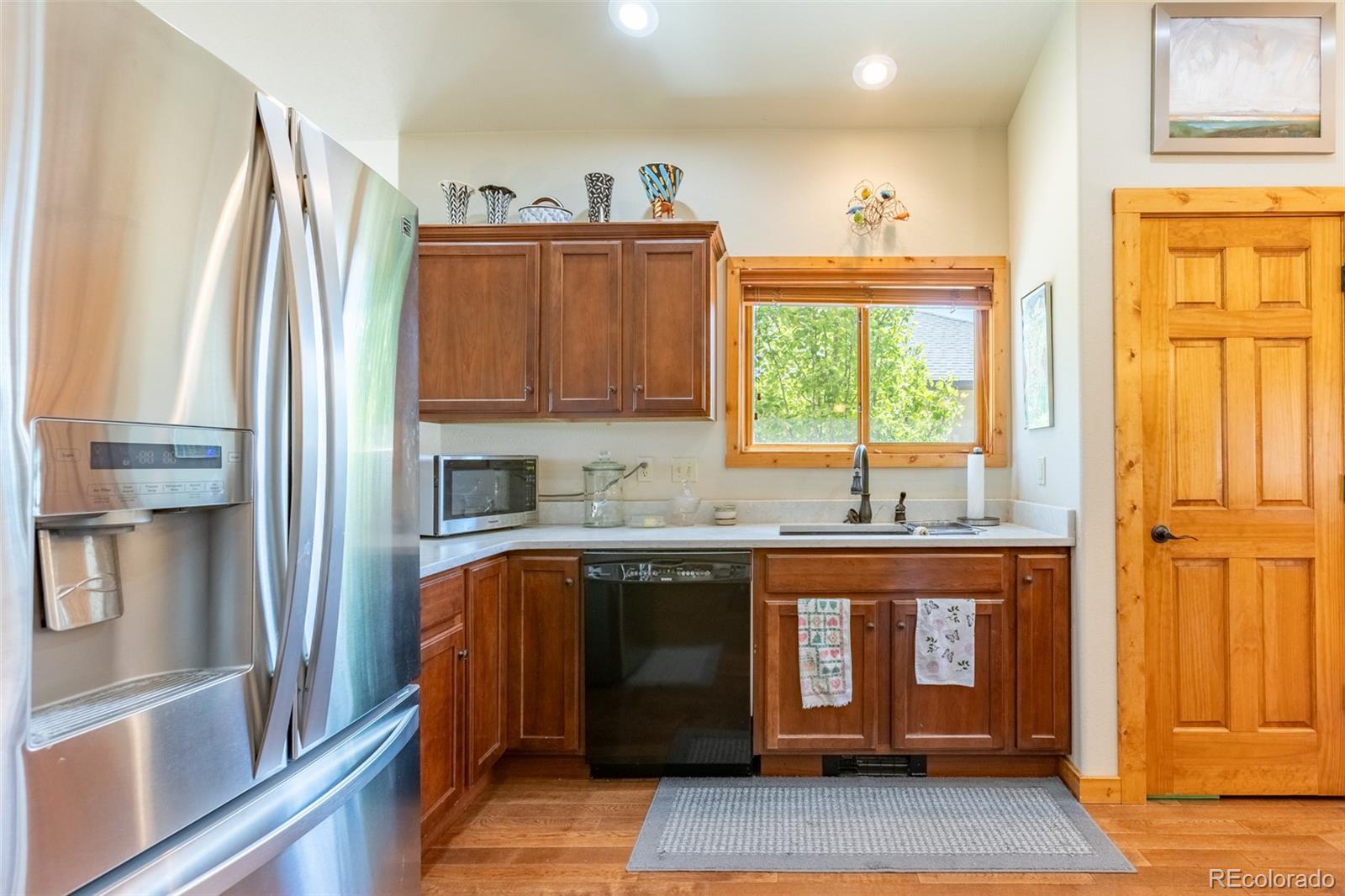 137 Starbuck Circle Salida, CO 81201 - Photo 21 of 50 a kitchen with stainless steel appliances granite countertop a refrigerator and a sink
