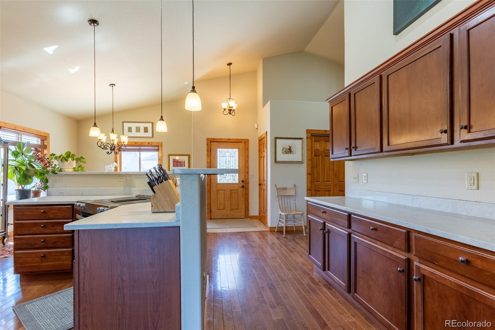 137 Starbuck Circle Salida, CO 81201 - Photo 25 of 50 a open kitchen with stainless steel appliances granite countertop a stove a sink and a wooden floors