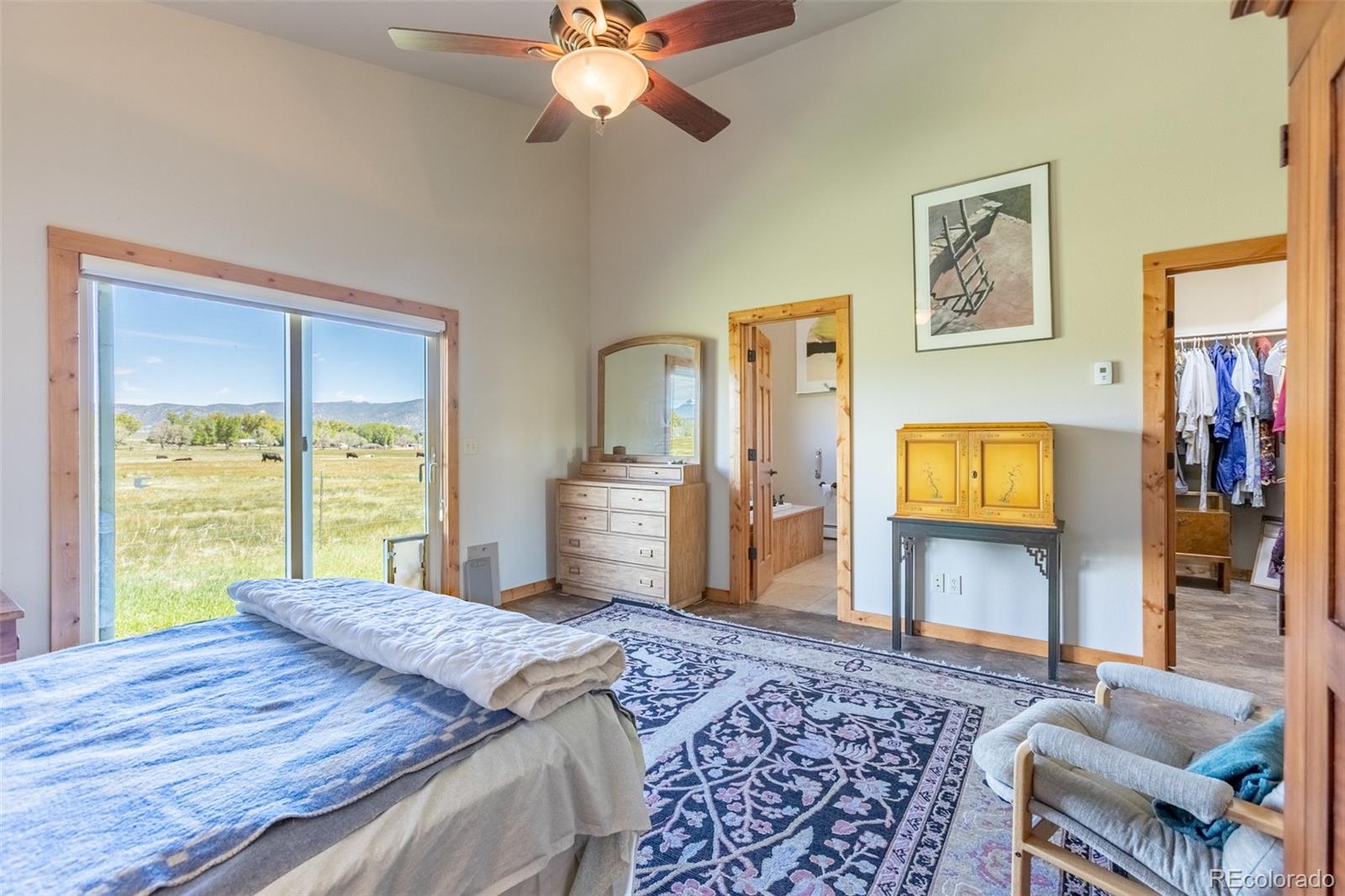 137 Starbuck Circle Salida, CO 81201 - Photo 35 of 50 a bedroom with a bed and wooden floor