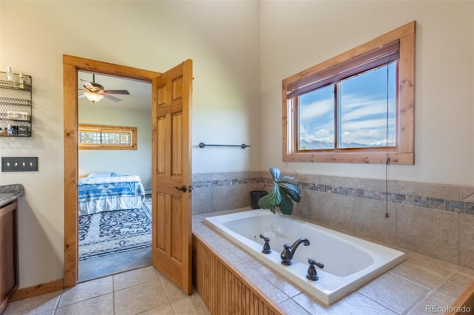 137 Starbuck Circle Salida, CO 81201 - Photo 37 of 50 a bathroom with a tub a sink and a window