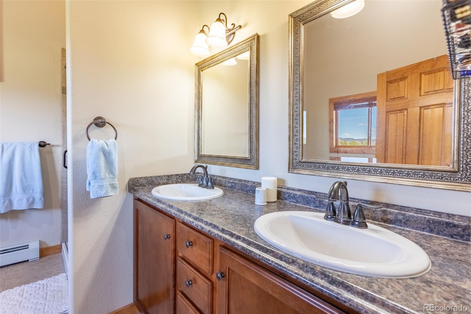 137 Starbuck Circle Salida, CO 81201 - Photo 40 of 50 a bathroom with a granite countertop sink and a mirror