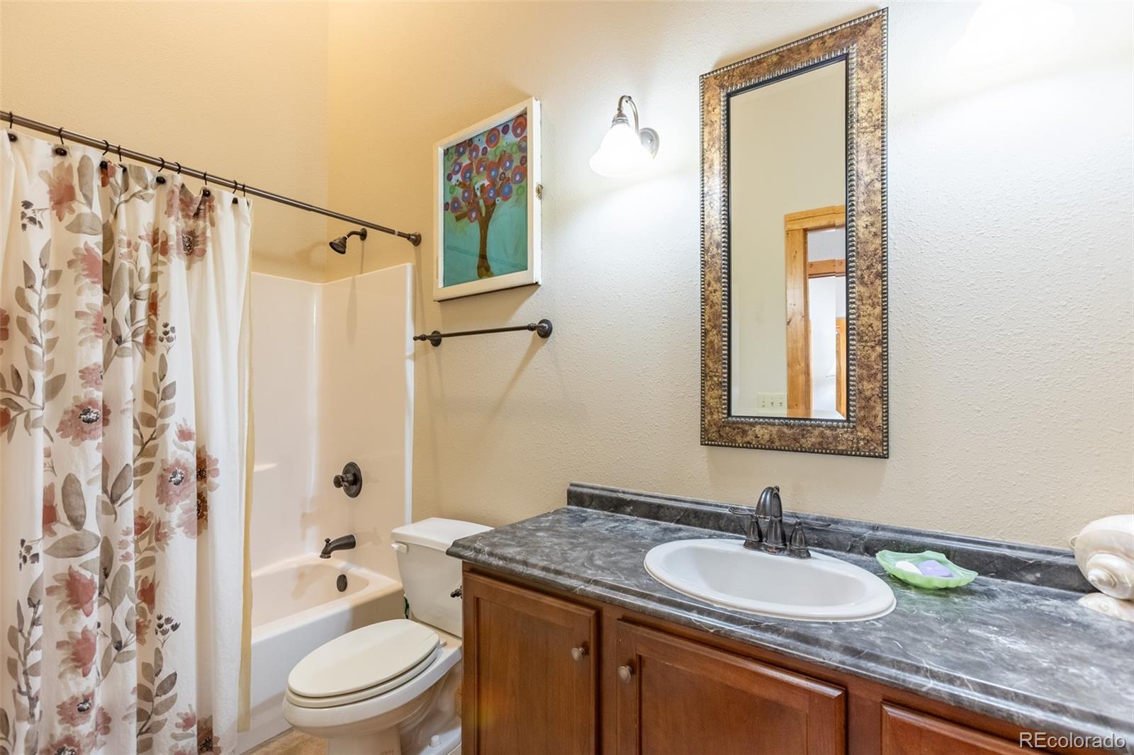 137 Starbuck Circle Salida, CO 81201 - Photo 47 of 50 a bathroom with a granite countertop sink toilet and shower