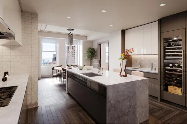 a living room with stainless steel appliances furniture a rug and a kitchen