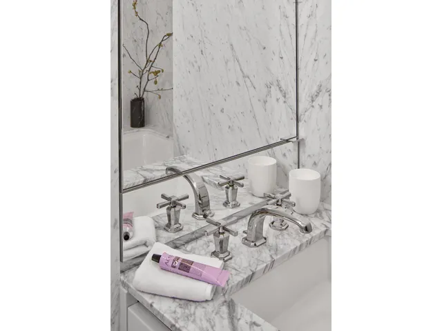 a bathroom with a granite countertop toilet a sink and bathtub