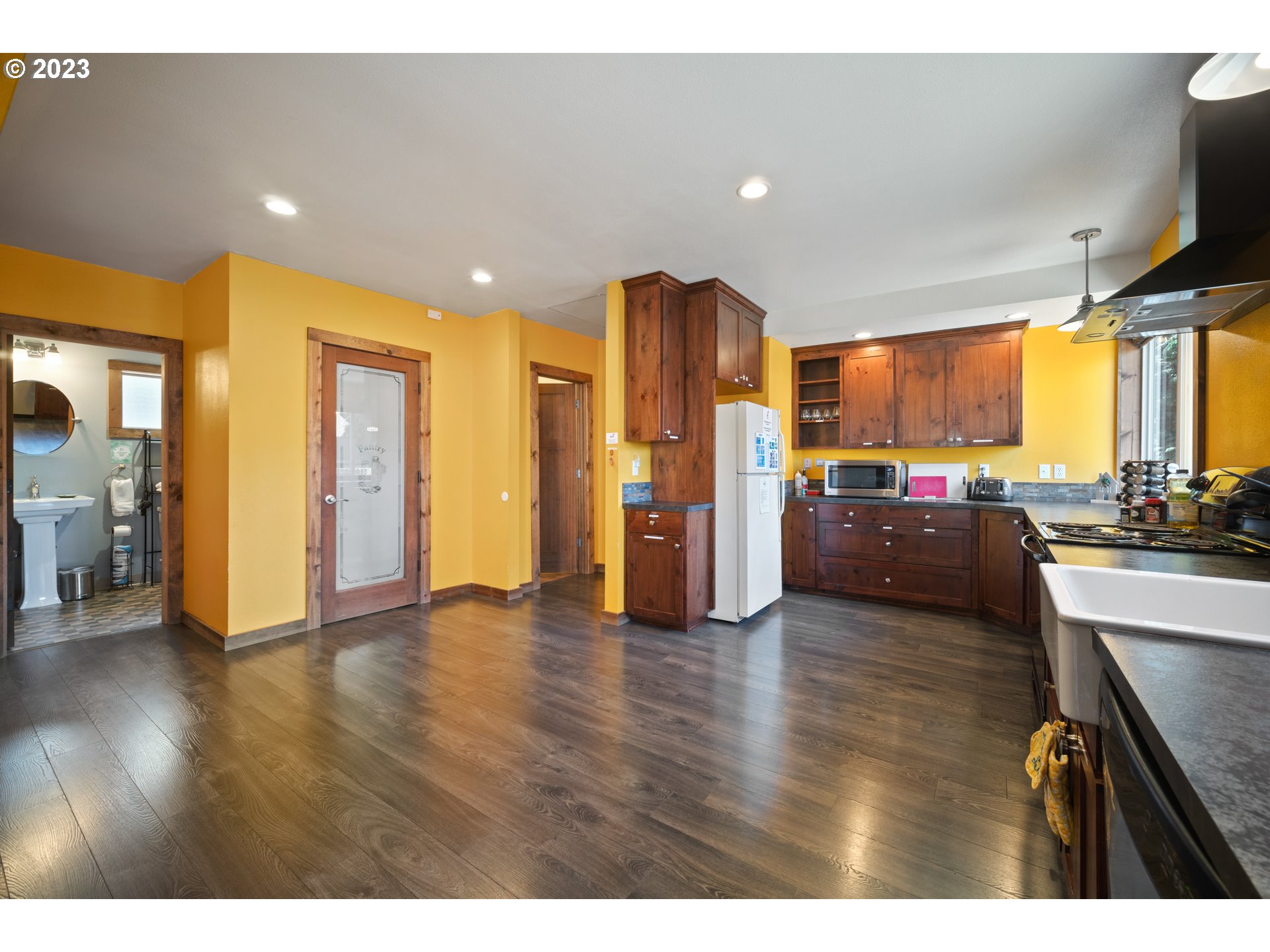709 West Fourth Plain Boulevard Vancouver, WA 98660 - Photo 9 of 29 a view of a kitchen with refrigerator and a stove top oven
