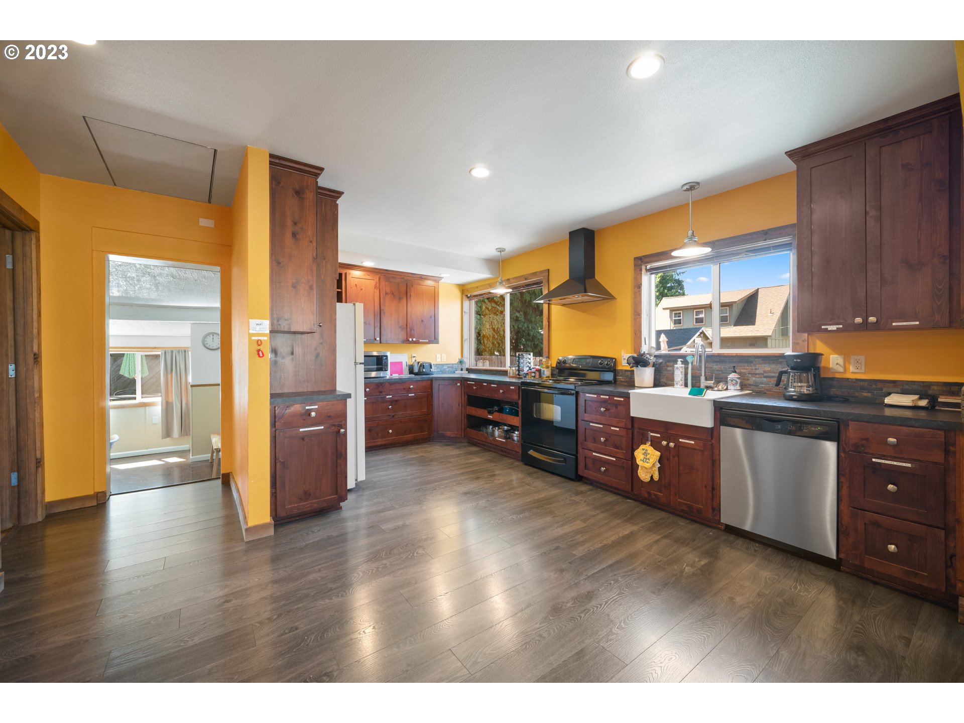 709 West Fourth Plain Boulevard Vancouver, WA 98660 - Photo 10 of 29 a open kitchen with stainless steel appliances granite countertop a refrigerator a sink dishwasher and wooden cabinets with wooden floor