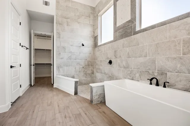 a bathroom with a bathtub and a sink