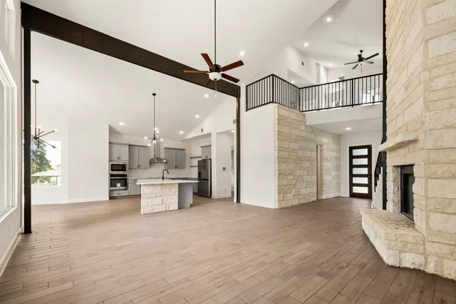 a view of a kitchen with a sink and a refrigerator