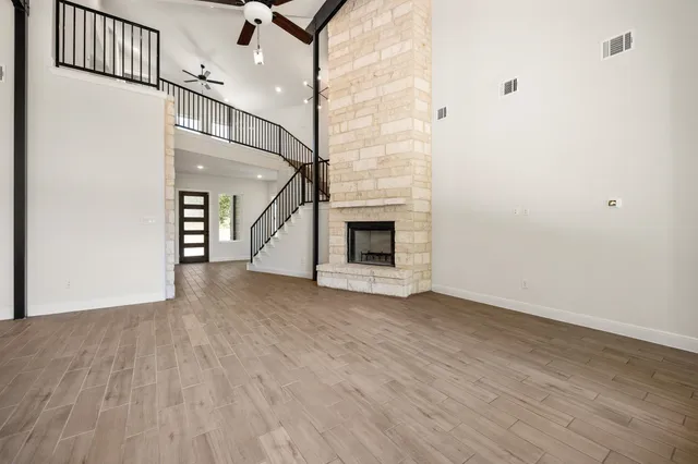 wooden floor in an empty room with a fireplace