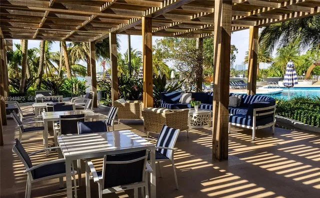 a view of a patio with table and chairs and potted plants