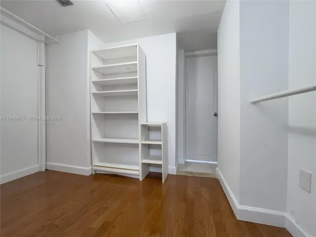 a view of walk in closet with empty racks