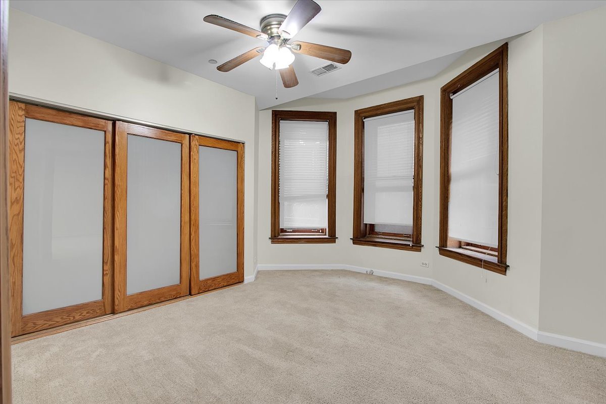 550 West Surf Street, Unit 115 Chicago, IL 60657 - Photo 11 of 18 an empty room with windows and fan