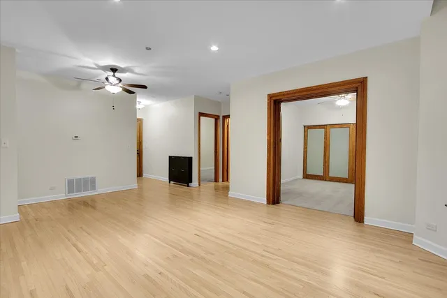 a view of an empty room with a ceiling fan
