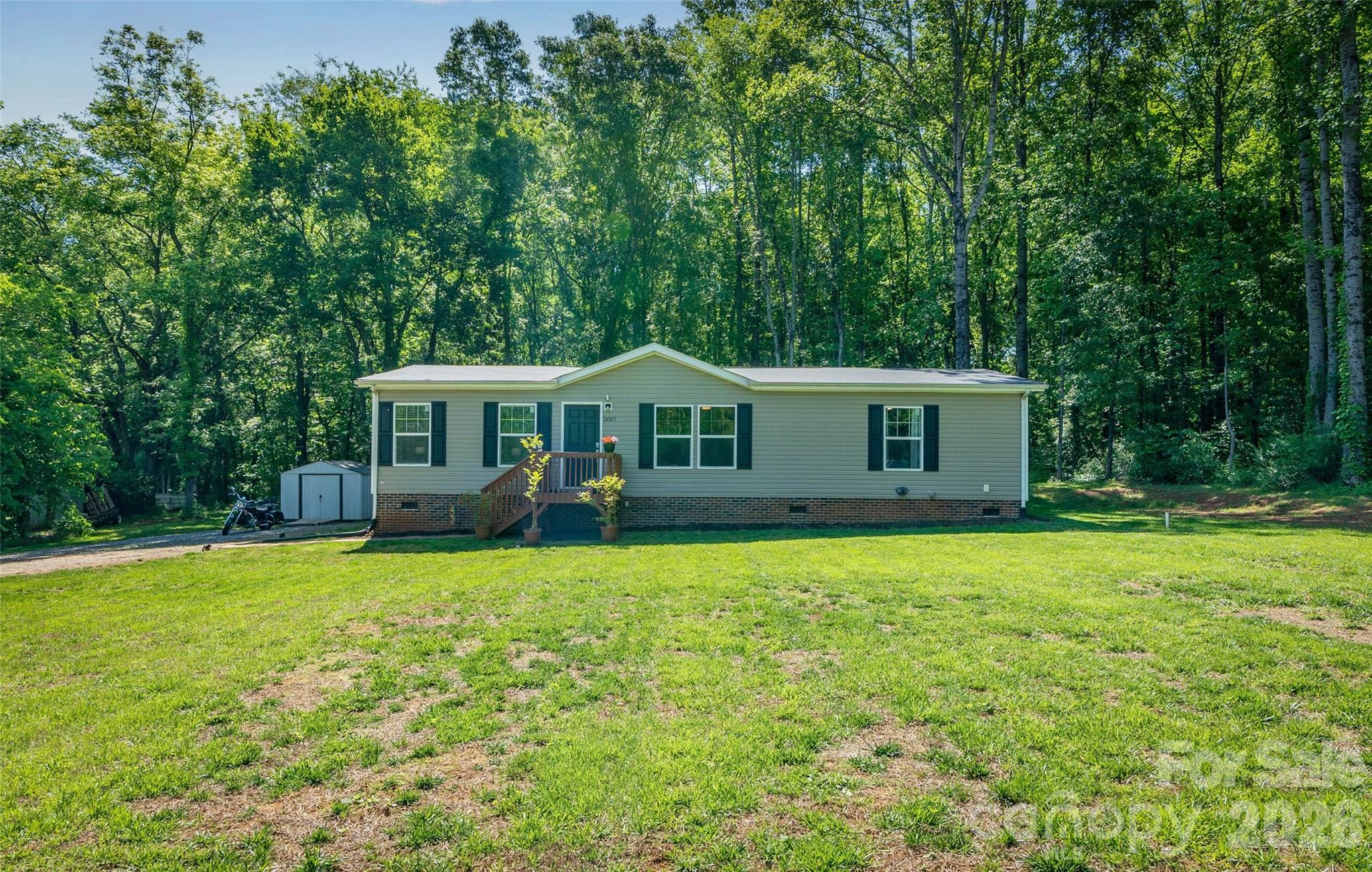5007 Carlos Road Catawba, NC 28609 - Photo 2 of 29 a front view of a house with a garden