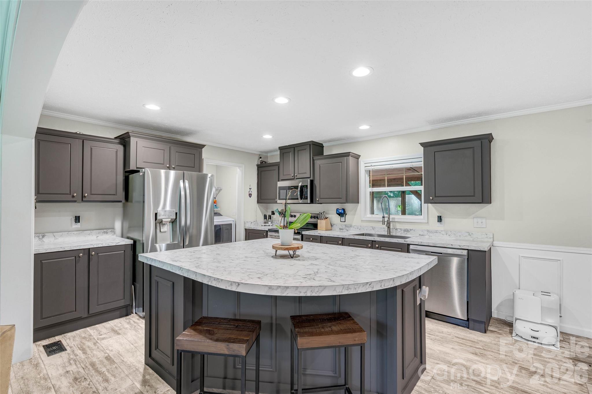 5007 Carlos Road Catawba, NC 28609 - Photo 6 of 29 a kitchen with stainless steel appliances granite countertop a table chairs sink refrigerator and microwave
