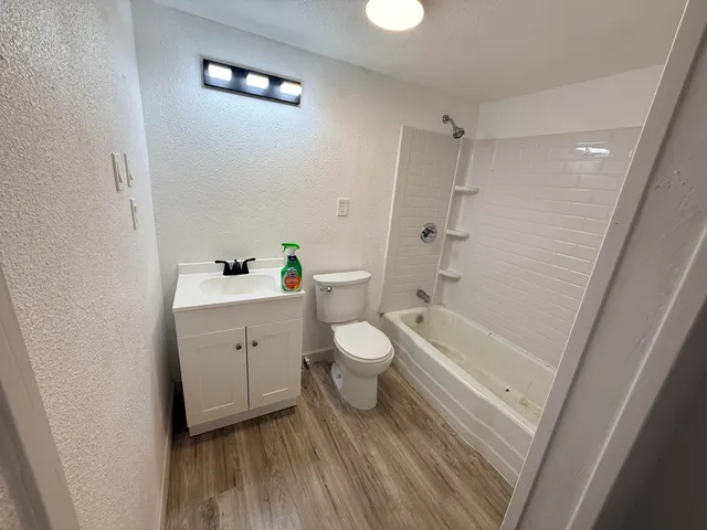 a bathroom with a toilet a sink and bathtub