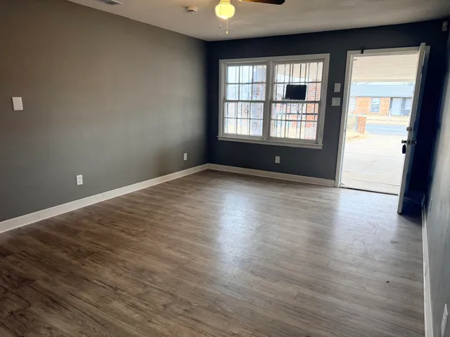 wooden floor in an empty room with a window