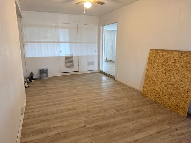 a view of a room with wooden floor and cabinet