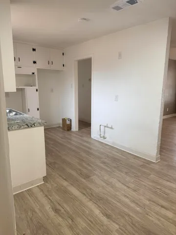 a view of storage and utility room with wooden floor