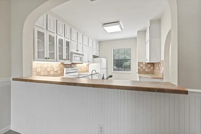 a view of a kitchen with granite countertop a sink and a window