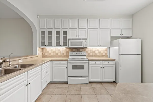a kitchen with cabinets stainless steel appliances and a sink