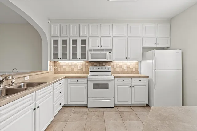 a kitchen with cabinets stainless steel appliances and a sink